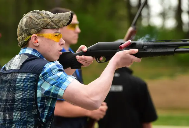 boy shooting, wearing safety glasses