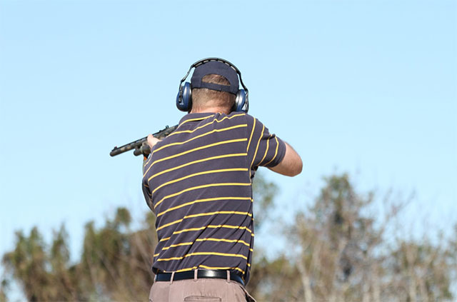 Person shooting with shotgun