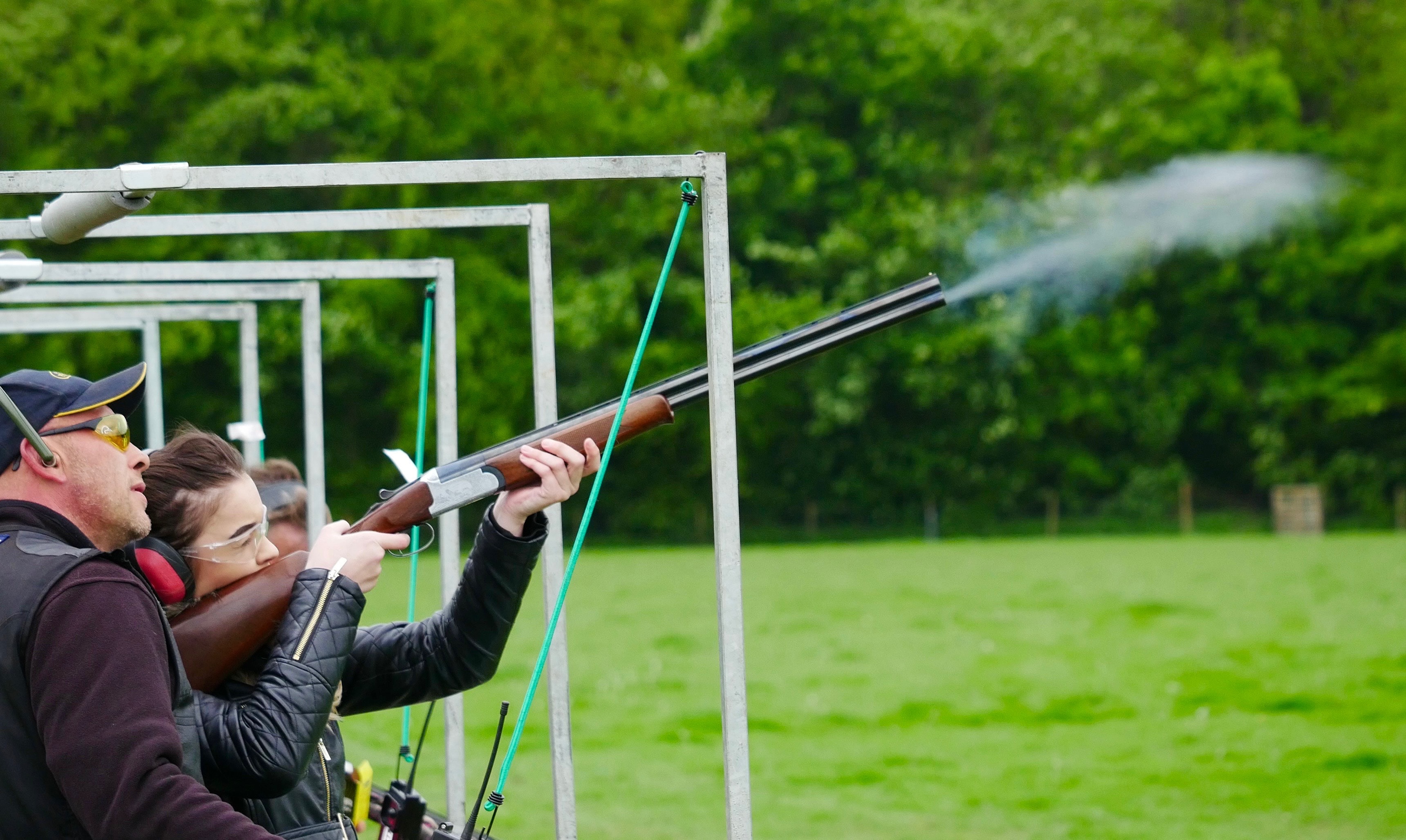 woman shooting clay pigeons