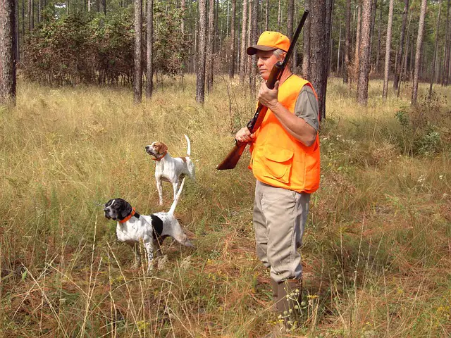 hunter holding a pump action shotgun