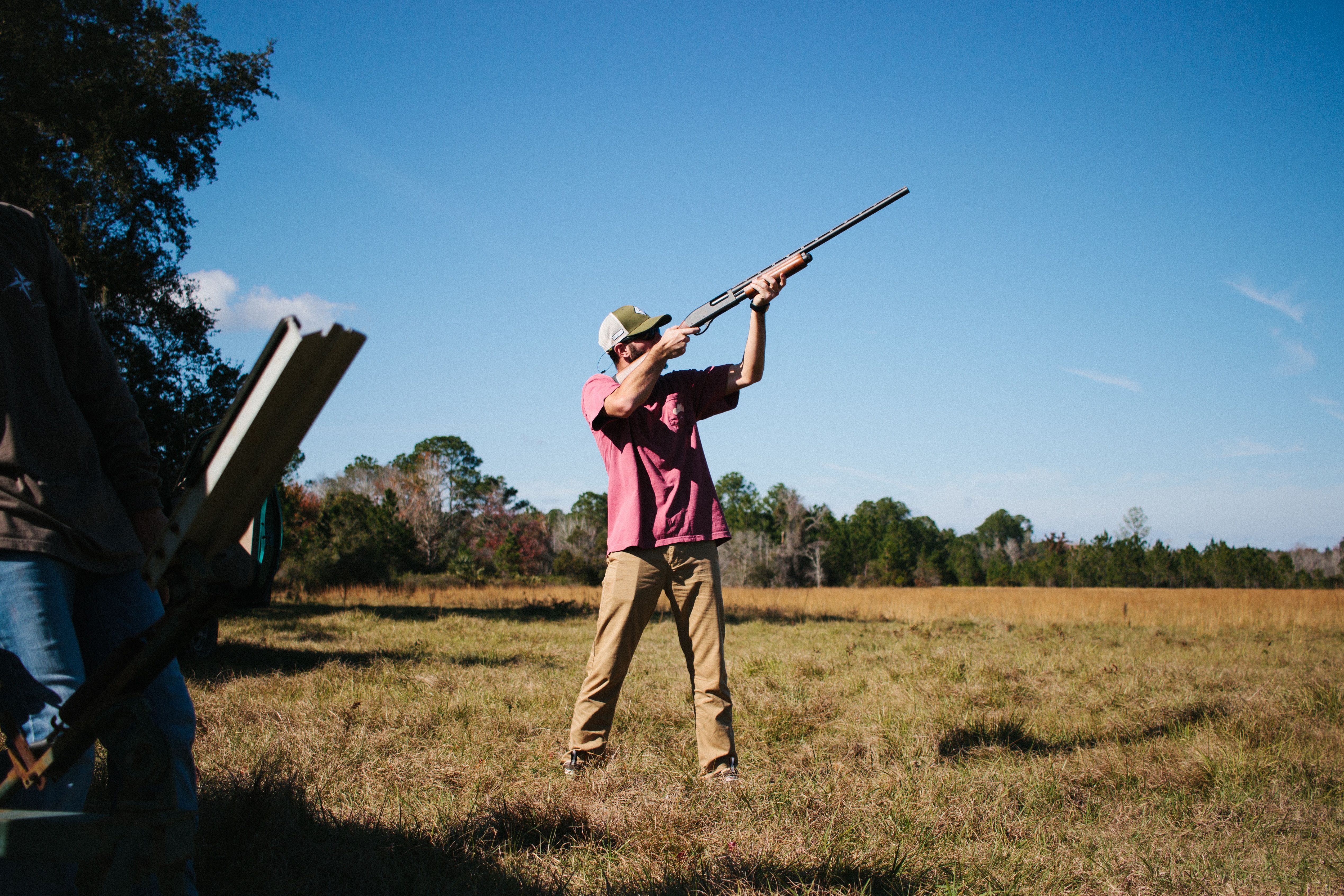 man shooting on clay pigeons