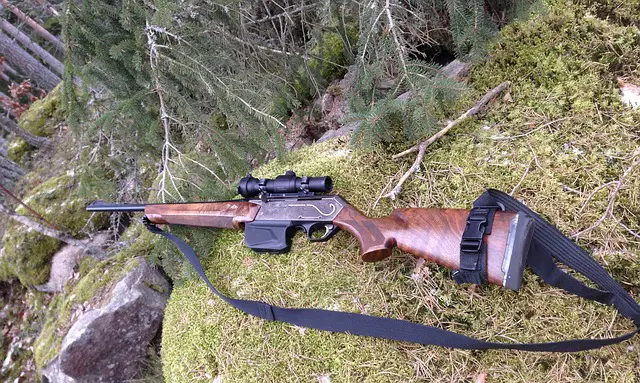 hunting rifle laid on rock